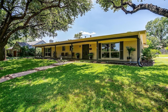 4408 Hildring Dr E, Fort Worth, TX 76109 - back of house featuring brick siding, a lawn, and a chimney