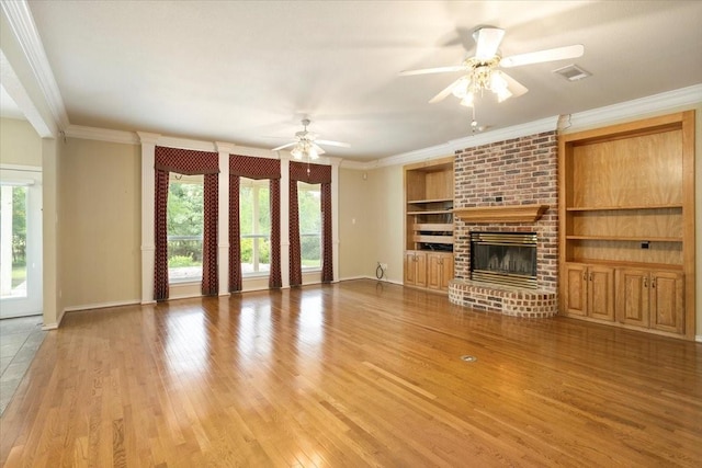 1642 Greenview Ct, Aledo, TX 76008 - unfurnished living room featuring crown molding, light wood finished floors, ceiling fan, a fireplace, and built in features