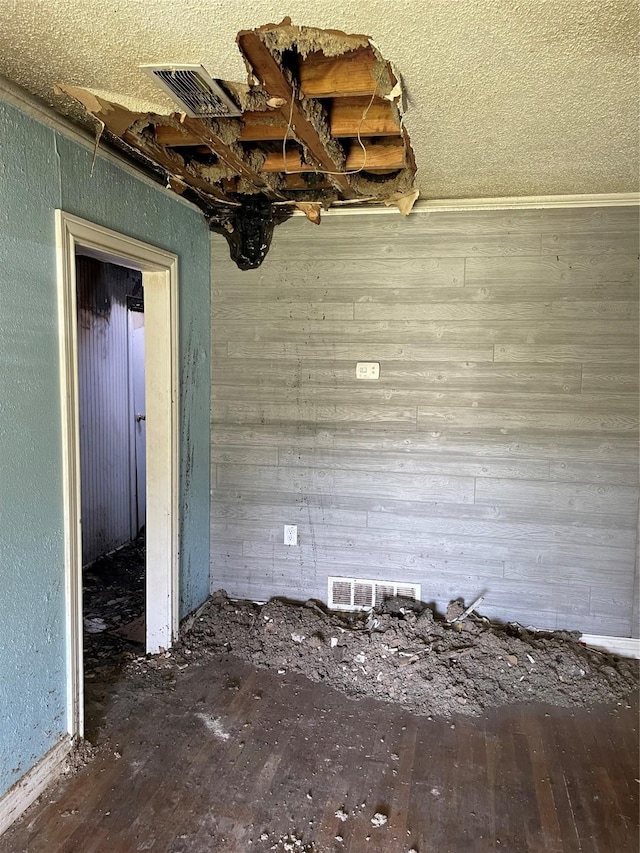 601 N Newsom St, Mineola, TX 75773 - empty room featuring wood finished floors and wood walls