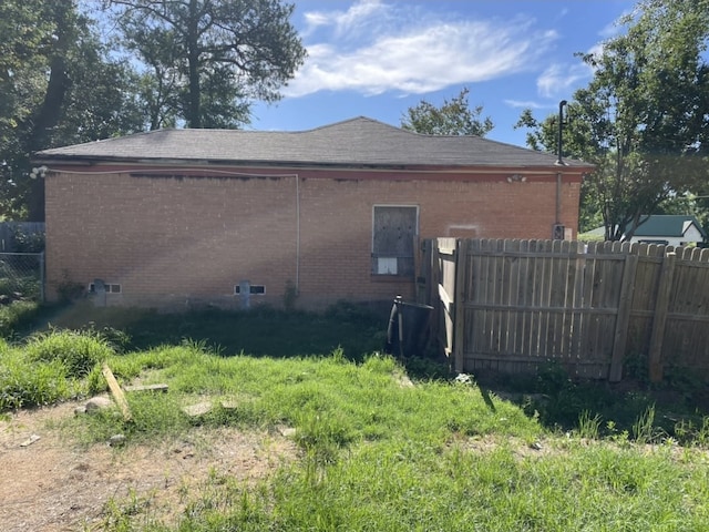 601 N Newsom St, Mineola, TX 75773 - view of side of home with brick siding and roof with shingles
