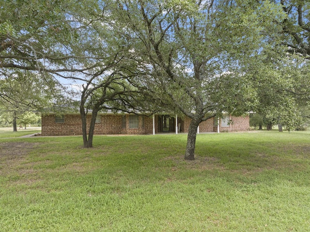 5161 N Hwy 271, Pittsburg, TX 75686 - obstructed view of property featuring a front lawn and brick siding