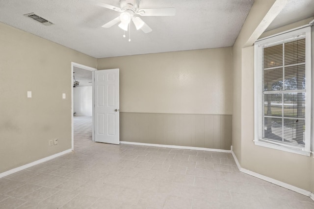 5161 N Hwy 271, Pittsburg, TX 75686 - empty room with a ceiling fan, a wainscoted wall, baseboards, and a textured ceiling