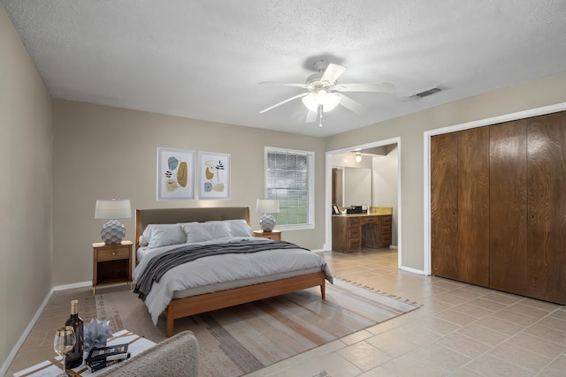 5161 N Hwy 271, Pittsburg, TX 75686 - bedroom featuring baseboards, a textured ceiling, a ceiling fan, and connected bathroom