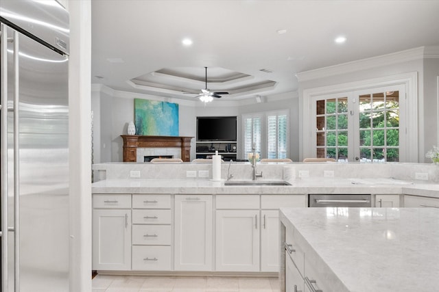 7000 Shalimar Ct, Colleyville, TX 76034 - kitchen featuring appliances with stainless steel finishes, a sink, light stone counters, ornamental molding, and white cabinets