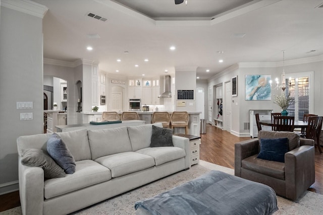7000 Shalimar Ct, Colleyville, TX 76034 - living room featuring light wood-style floors, recessed lighting, a ceiling fan, arched walkways, and a chandelier
