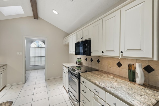 2420 Cross Timbers Trl, Arlington, TX 76006 - kitchen featuring black microwave, stainless steel electric range oven, a skylight, backsplash, and light tile patterned floors