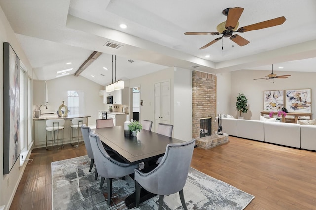 2420 Cross Timbers Trl, Arlington, TX 76006 - dining space featuring dark wood-style floors, a ceiling fan, a brick fireplace, vaulted ceiling, and recessed lighting