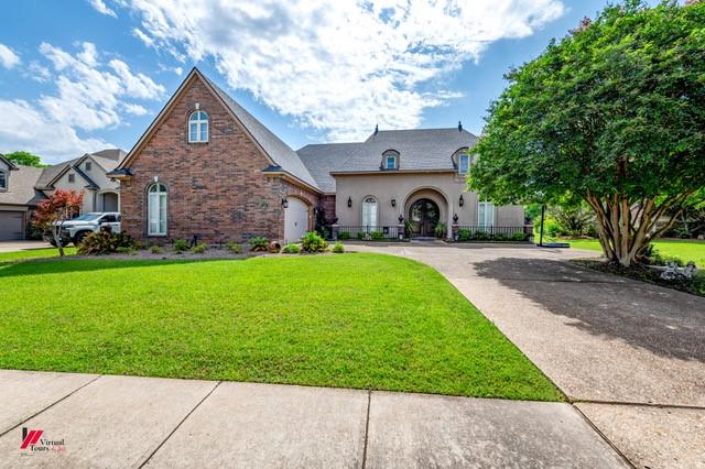 520 Canterbury Ln, Bossier City, LA 71111 - french provincial home featuring driveway, a front lawn, and an attached garage
