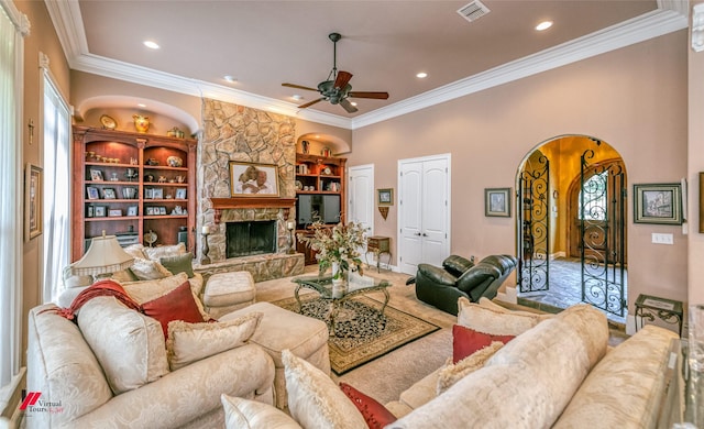 520 Canterbury Ln, Bossier City, LA 71111 - living room featuring a ceiling fan, arched walkways, crown molding, a fireplace, and recessed lighting