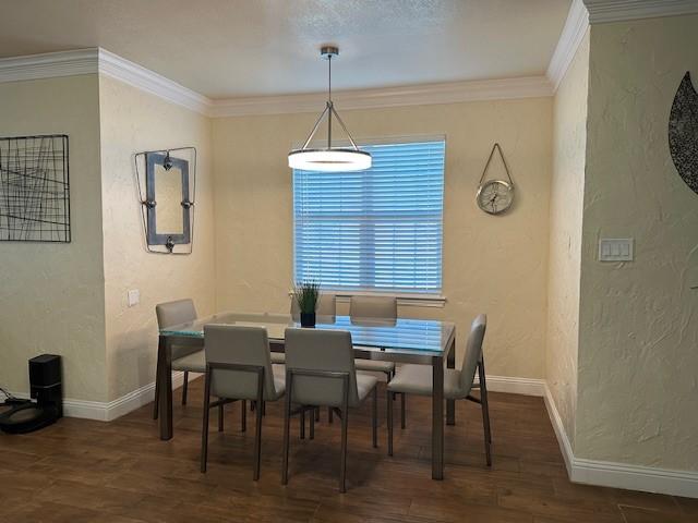 749 Ranch Rd, Fort Worth, TX 76131 - dining space with a textured wall, wood finished floors, and ornamental molding