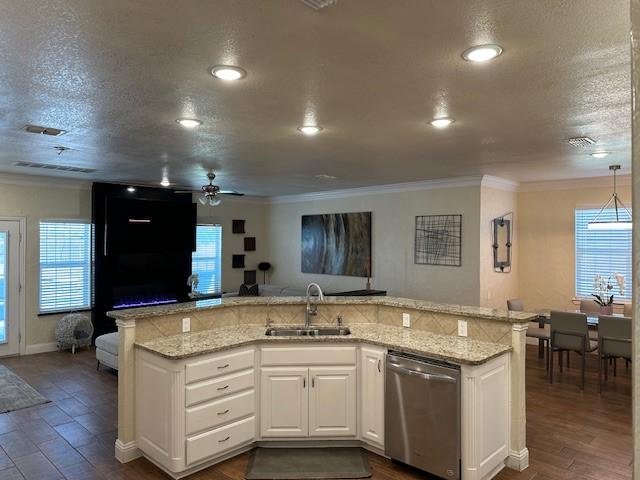 749 Ranch Rd, Fort Worth, TX 76131 - kitchen featuring stainless steel dishwasher, a ceiling fan, crown molding, open floor plan, and white cabinetry
