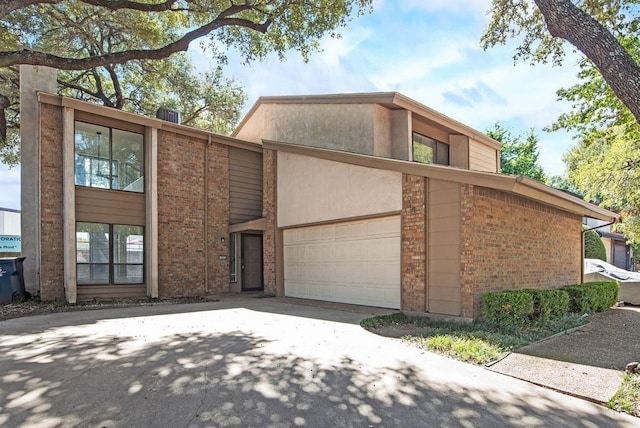 1822 Highbrook Ct, Garland, TX 75044 - mid-century modern home featuring brick siding, concrete driveway, and an attached garage