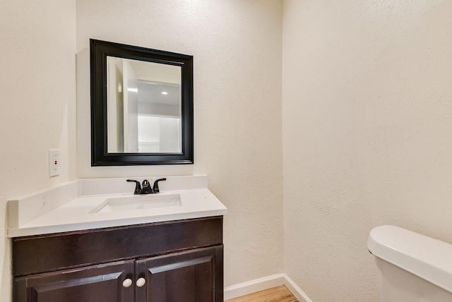 1822 Highbrook Ct, Garland, TX 75044 - bathroom featuring toilet, vanity, baseboards, and wood finished floors