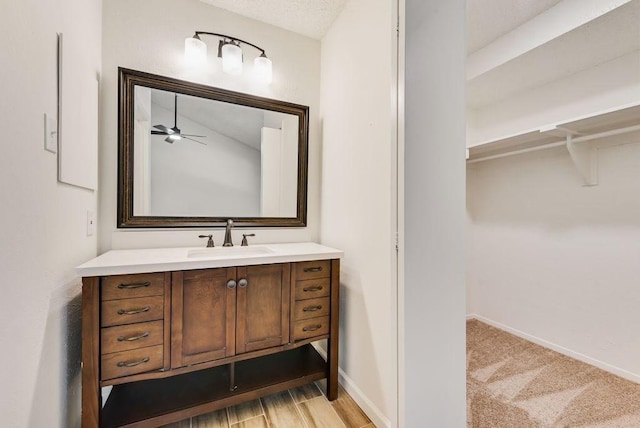 1822 Highbrook Ct, Garland, TX 75044 - bathroom featuring vanity, a spacious closet, ceiling fan, and baseboards