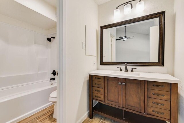 1822 Highbrook Ct, Garland, TX 75044 - full bathroom featuring vanity, wood finished floors, toilet, a ceiling fan, and bathtub / shower combination