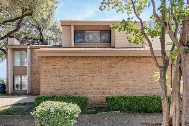 1822 Highbrook Ct, Garland, TX 75044 - view of home's exterior featuring brick siding and a chimney