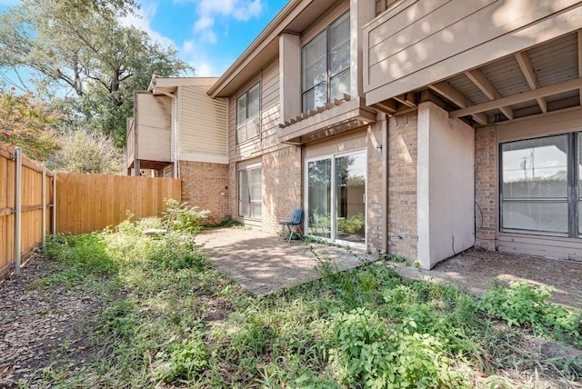 1822 Highbrook Ct, Garland, TX 75044 - rear view of property featuring brick siding and a patio