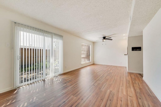 1822 Highbrook Ct, Garland, TX 75044 - empty room with ceiling fan, wood finished floors, a textured ceiling, and baseboards