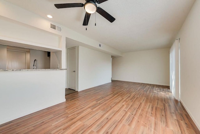 1822 Highbrook Ct, Garland, TX 75044 - unfurnished living room featuring light wood finished floors, ceiling fan, and recessed lighting