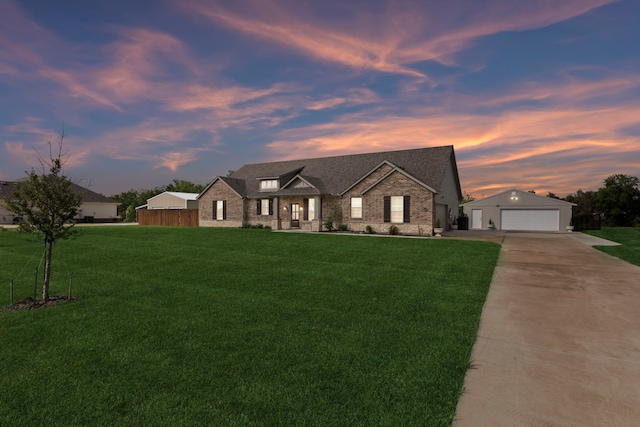 2410 Blackjack Oak Rd, Oak Ridge, TX 75161 - view of front facade with a lawn, driveway, brick siding, and an outbuilding