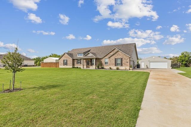 2410 Blackjack Oak Rd, Oak Ridge, TX 75161 - view of front of home featuring brick siding, a detached garage, concrete driveway, and roof with shingles
