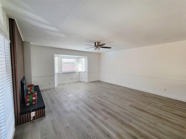3402 Jones Dr, Rowlett, TX 75088 - unfurnished room featuring light wood-style floors, a ceiling fan, and baseboards