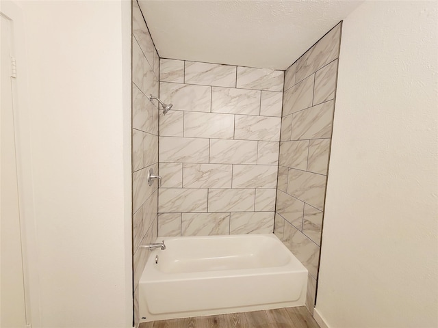 3402 Jones Dr, Rowlett, TX 75088 - bathroom with wood finished floors, tub / shower combination, and baseboards