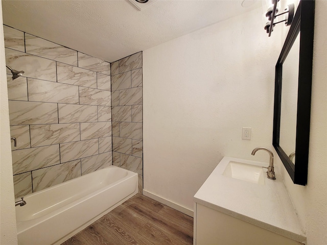 3402 Jones Dr, Rowlett, TX 75088 - full bath featuring wood finished floors, vanity, bathtub / shower combination, baseboards, and a textured ceiling
