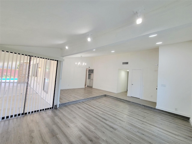 3402 Jones Dr, Rowlett, TX 75088 - spare room featuring a chandelier, wood finished floors, lofted ceiling, baseboards, and recessed lighting