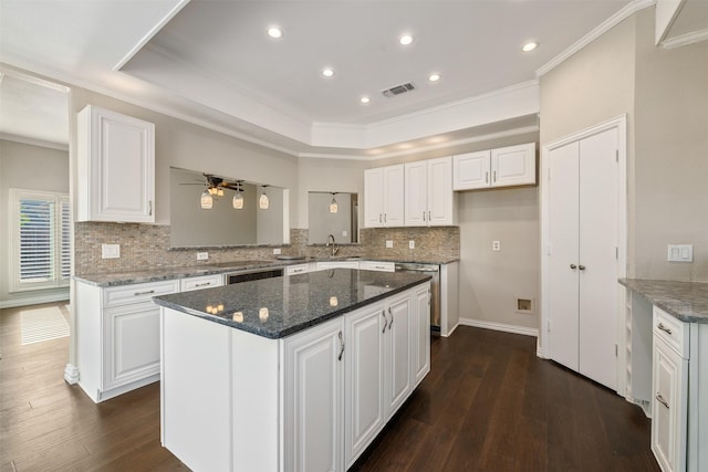 9120 Nob Hill Dr, North Richland Hills, TX 76182 - kitchen featuring ornamental molding, tasteful backsplash, a center island, dark wood-style flooring, and ceiling fan