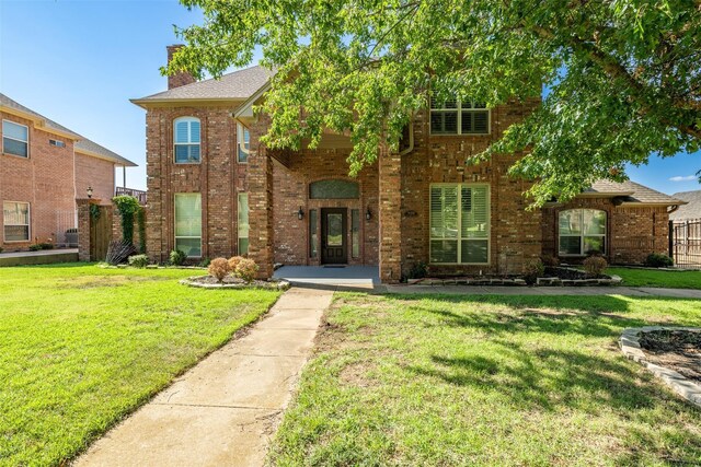 9120 Nob Hill Dr, North Richland Hills, TX 76182 - traditional home featuring brick siding, a front yard, and a chimney