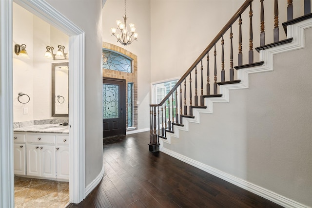 9120 Nob Hill Dr, North Richland Hills, TX 76182 - entrance foyer with a towering ceiling, baseboards, stairs, a chandelier, and dark wood-style flooring
