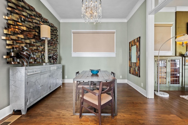 610 W Chestnut St, Denison, TX 75020 - dining space featuring wood finished floors, a chandelier, ornamental molding, and baseboards