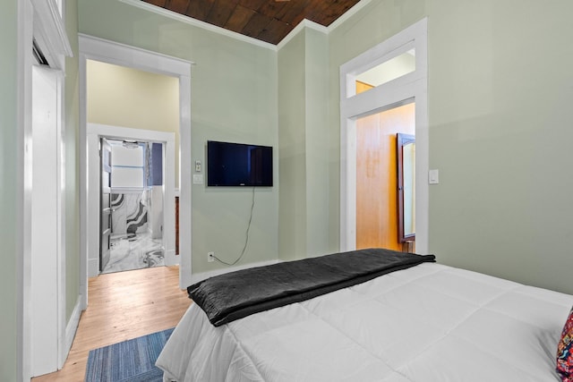 610 W Chestnut St, Denison, TX 75020 - bedroom featuring ornamental molding, light wood-style floors, and wood ceiling