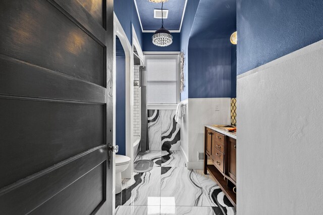 610 W Chestnut St, Denison, TX 75020 - full bath featuring marble look tiles, vanity, toilet, a textured wall, and shower / bath combination