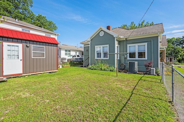 610 W Chestnut St, Denison, TX 75020 - rear view of property featuring a chimney, cooling unit, and an outdoor structure
