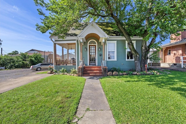 610 W Chestnut St, Denison, TX 75020 - view of front of house with a porch and a front yard