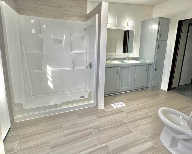 6818 Spring Shower Ct, Krum, TX 76249 - bathroom with a shower stall, double vanity, and a bidet