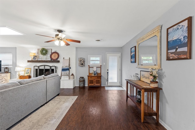 201 Randy Dr, Woodway, TX 76712 - living room featuring ceiling fan, baseboards, dark wood-style flooring, and a fireplace