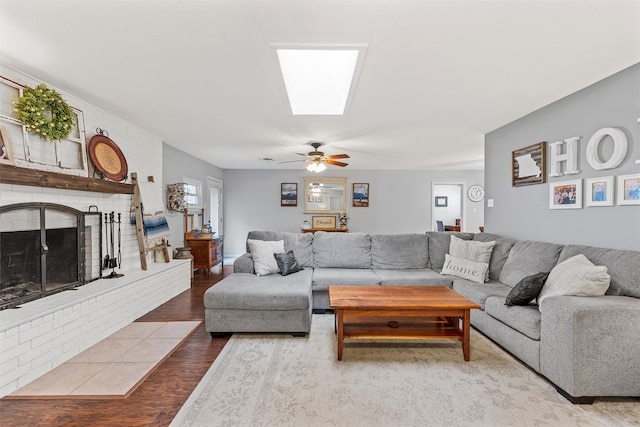 201 Randy Dr, Woodway, TX 76712 - living room featuring wood finished floors, ceiling fan, and a brick fireplace
