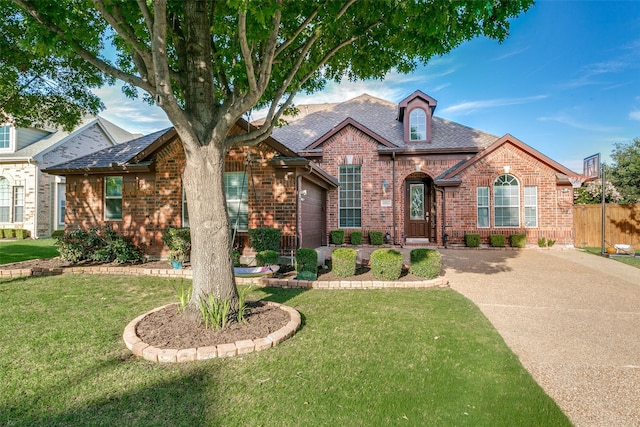 6004 Grand Meadow Ln, Flower Mound, TX 75028 - view of front facade with brick siding, concrete driveway, and a garage