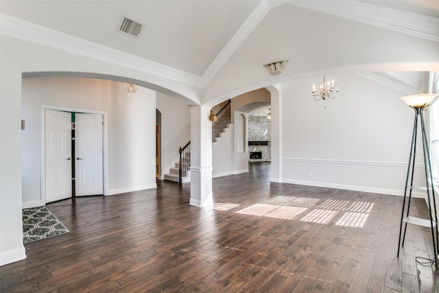 6004 Grand Meadow Ln, Flower Mound, TX 75028 - unfurnished living room with arched walkways, stairway, lofted ceiling, a chandelier, and ornamental molding