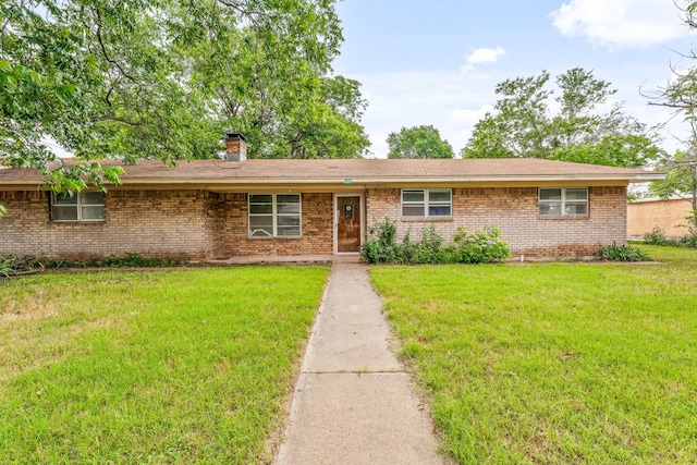 209 S Austin St, De Leon, TX 76444 - single story home with brick siding, a front lawn, and a chimney