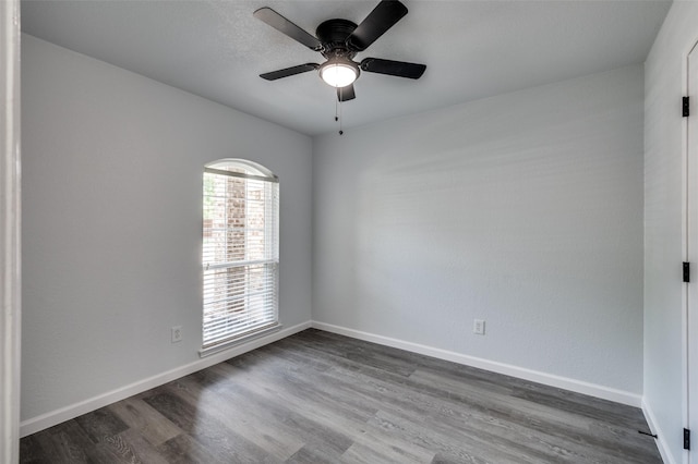 7708 Partridge Dr, Watauga, TX 76148 - empty room with dark wood-style flooring, baseboards, and ceiling fan