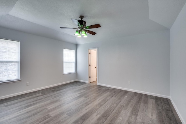 7708 Partridge Dr, Watauga, TX 76148 - spare room with wood finished floors, a ceiling fan, baseboards, and a textured ceiling