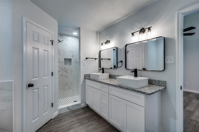 7708 Partridge Dr, Watauga, TX 76148 - full bath with wood finished floors, a marble finish shower, and double vanity