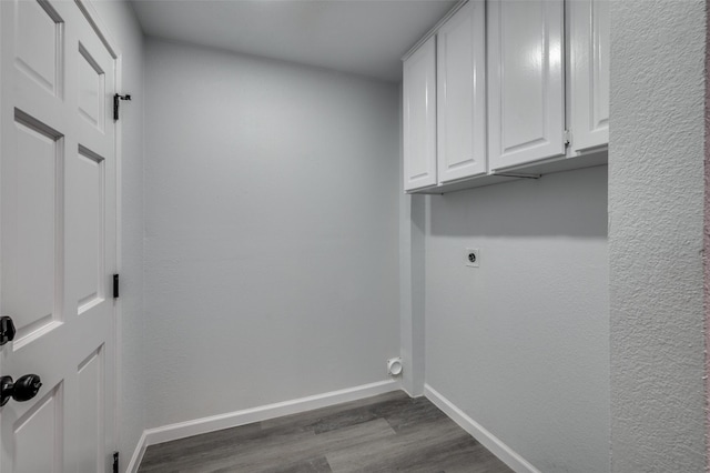 7708 Partridge Dr, Watauga, TX 76148 - washroom with hookup for an electric dryer, cabinet space, dark wood-style floors, and baseboards