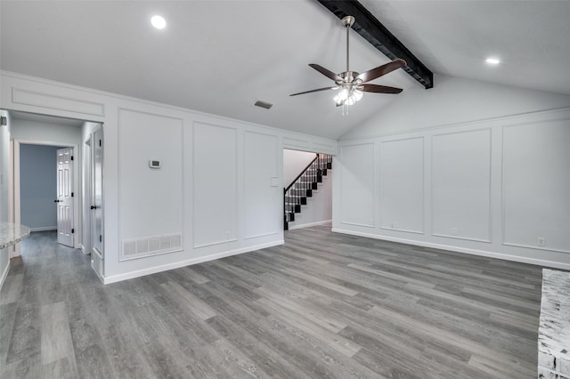 7708 Partridge Dr, Watauga, TX 76148 - unfurnished living room with a decorative wall, ceiling fan, wood finished floors, and stairs
