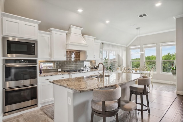 16001 Gladewater Ter, Prosper, TX 75078 - kitchen featuring appliances with stainless steel finishes, vaulted ceiling, a sink, crown molding, and tasteful backsplash