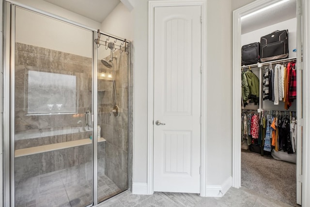 16001 Gladewater Ter, Prosper, TX 75078 - bathroom featuring a shower stall, a walk in closet, tile patterned flooring, and baseboards